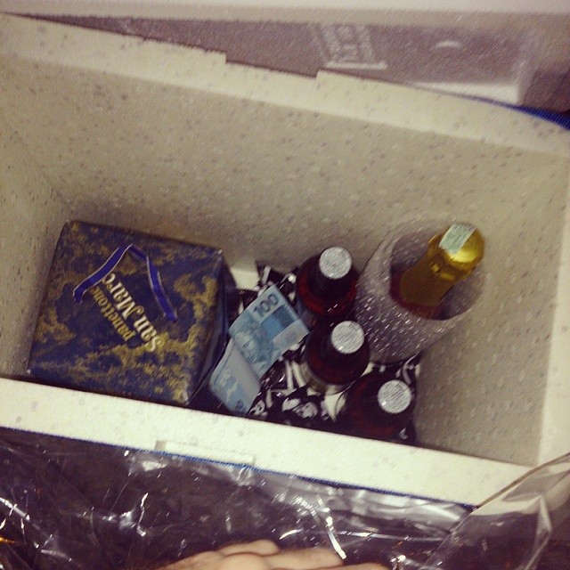 a bottle and several bottles of beer in a box