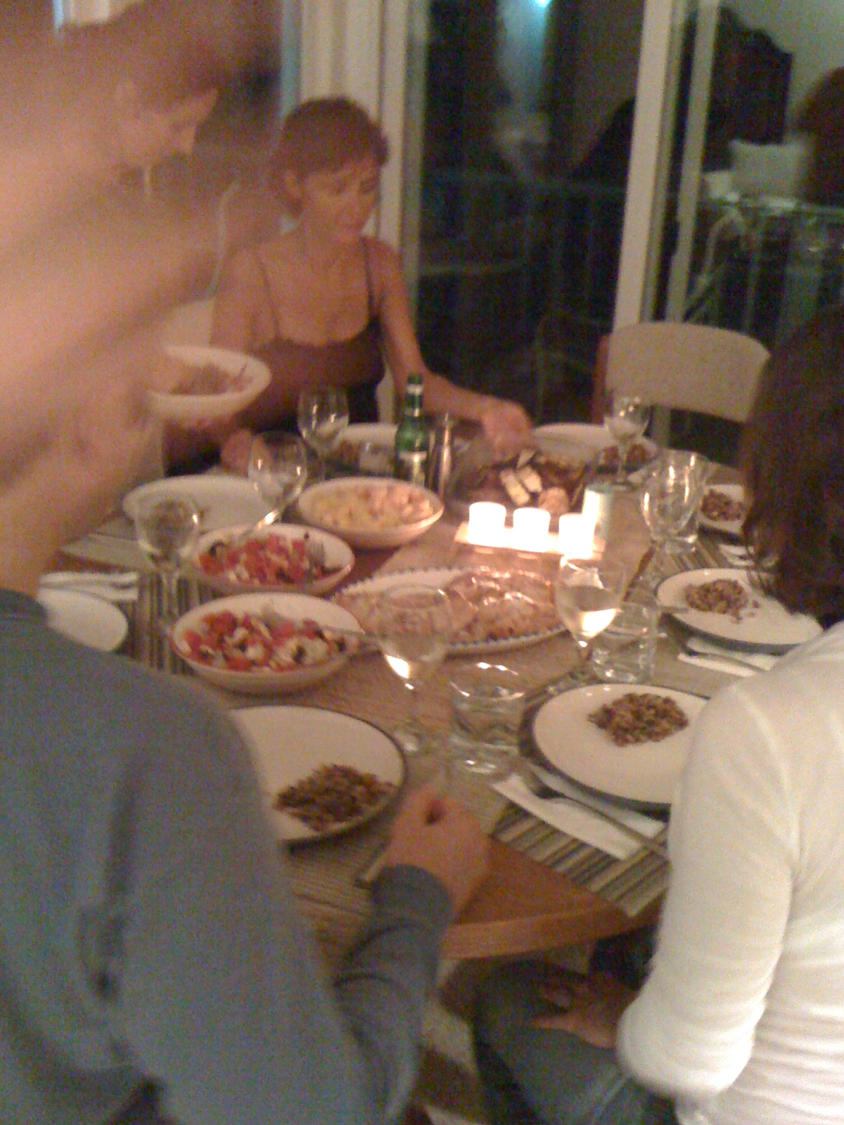 the family at a dinner table is enjoying the evening meal