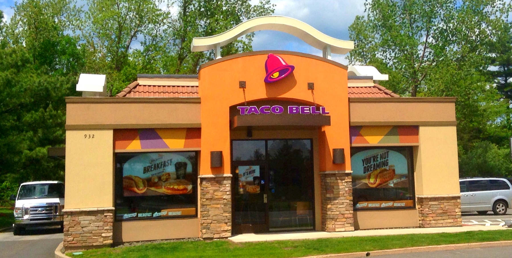 a small orange store with a truck parked in front