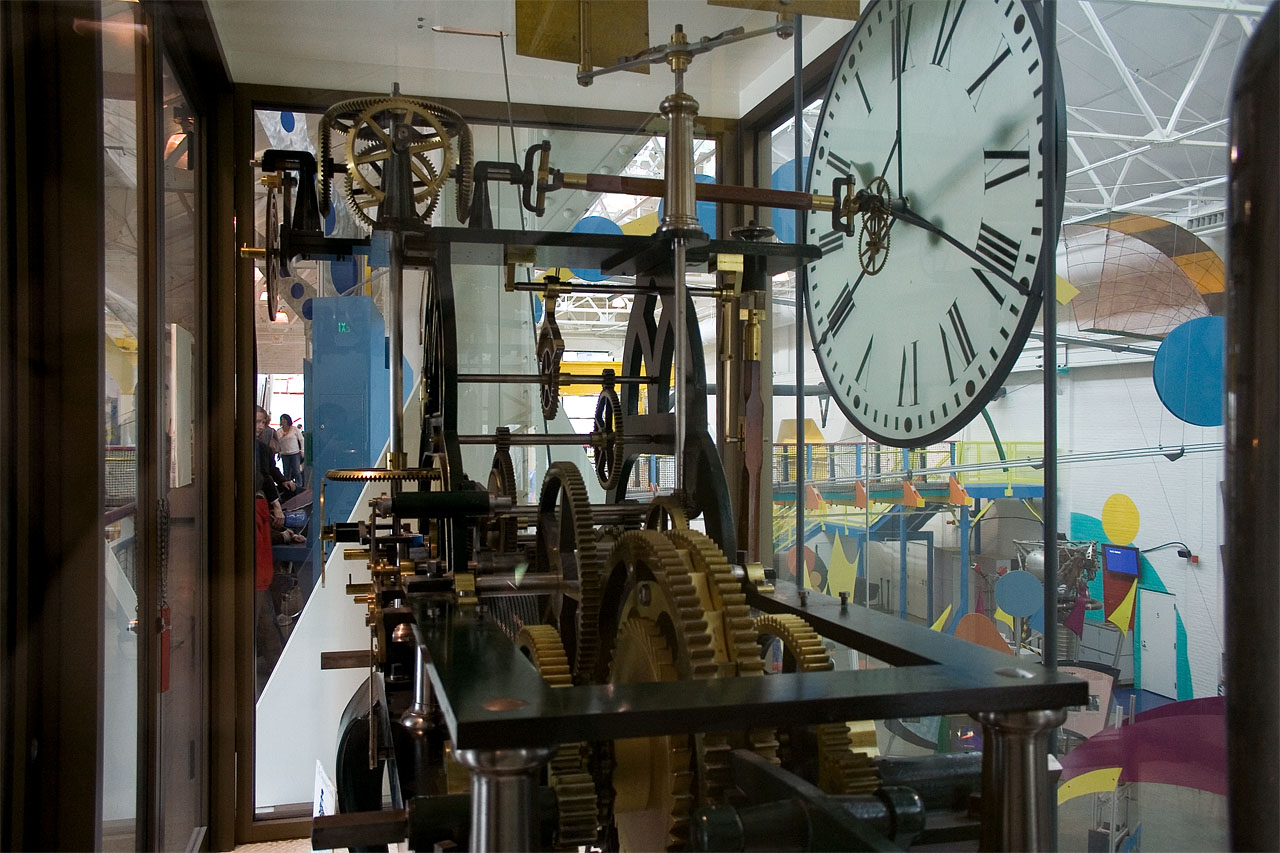 the large clock is sitting inside a building