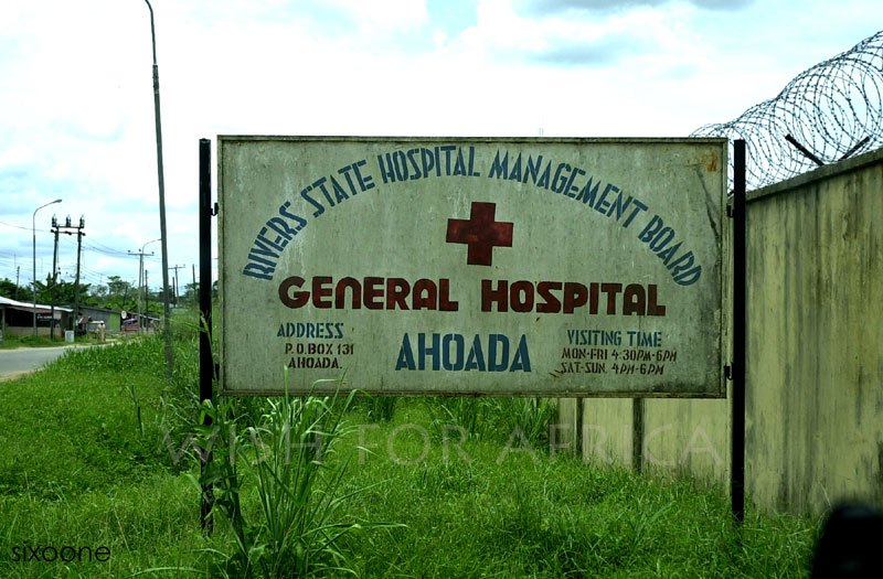 an old hospital sign has been vandalized