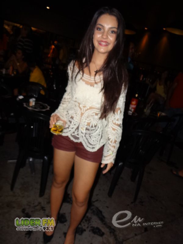 a woman with short shorts and lacy shirt at a party