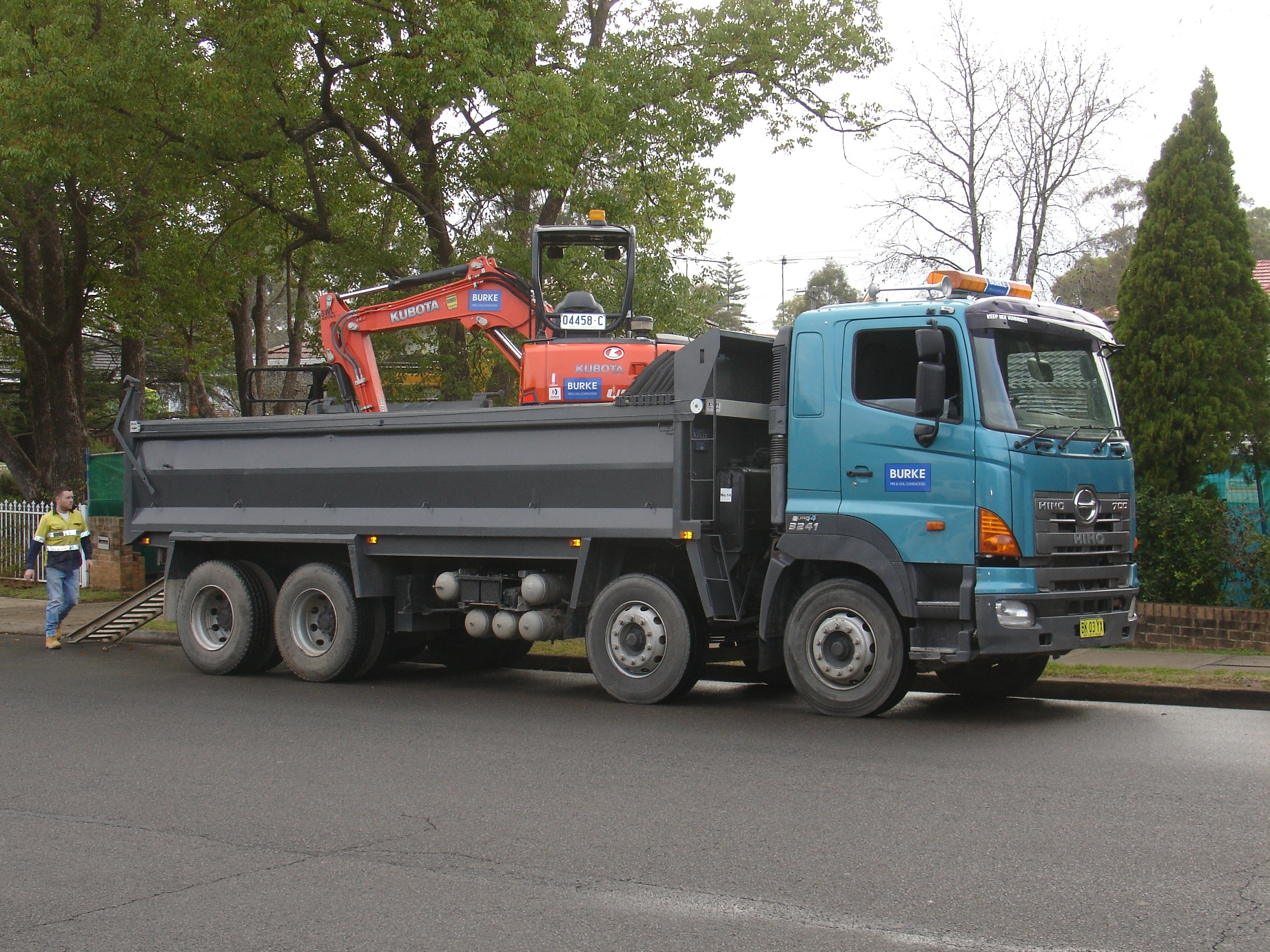 a large truck parked next to some trees