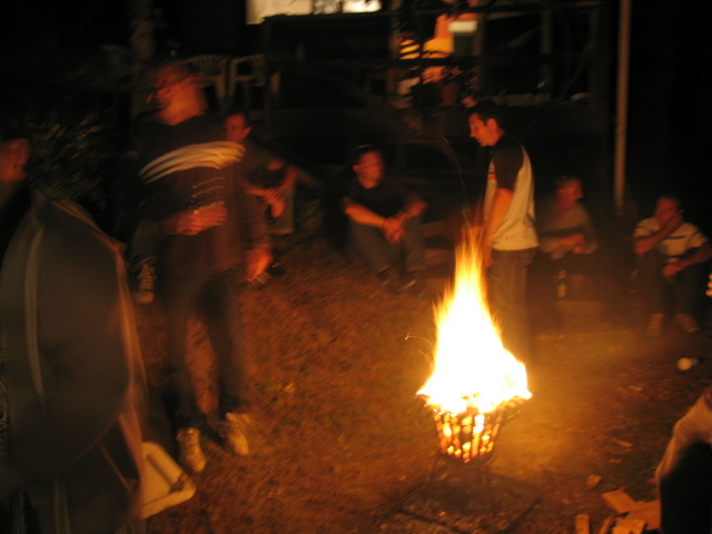 people gathered around the campfire at night