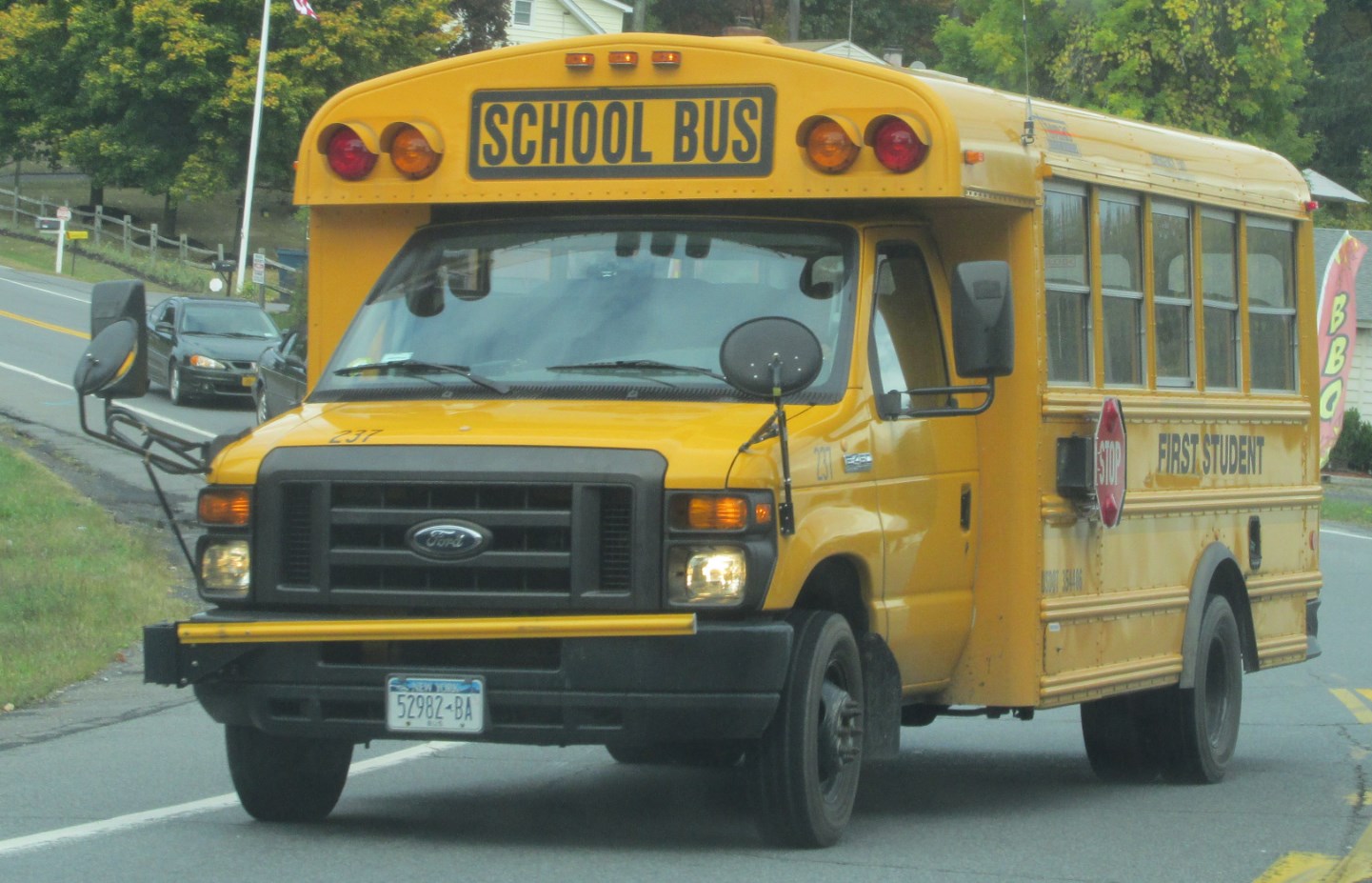 a school bus riding on the street in the day