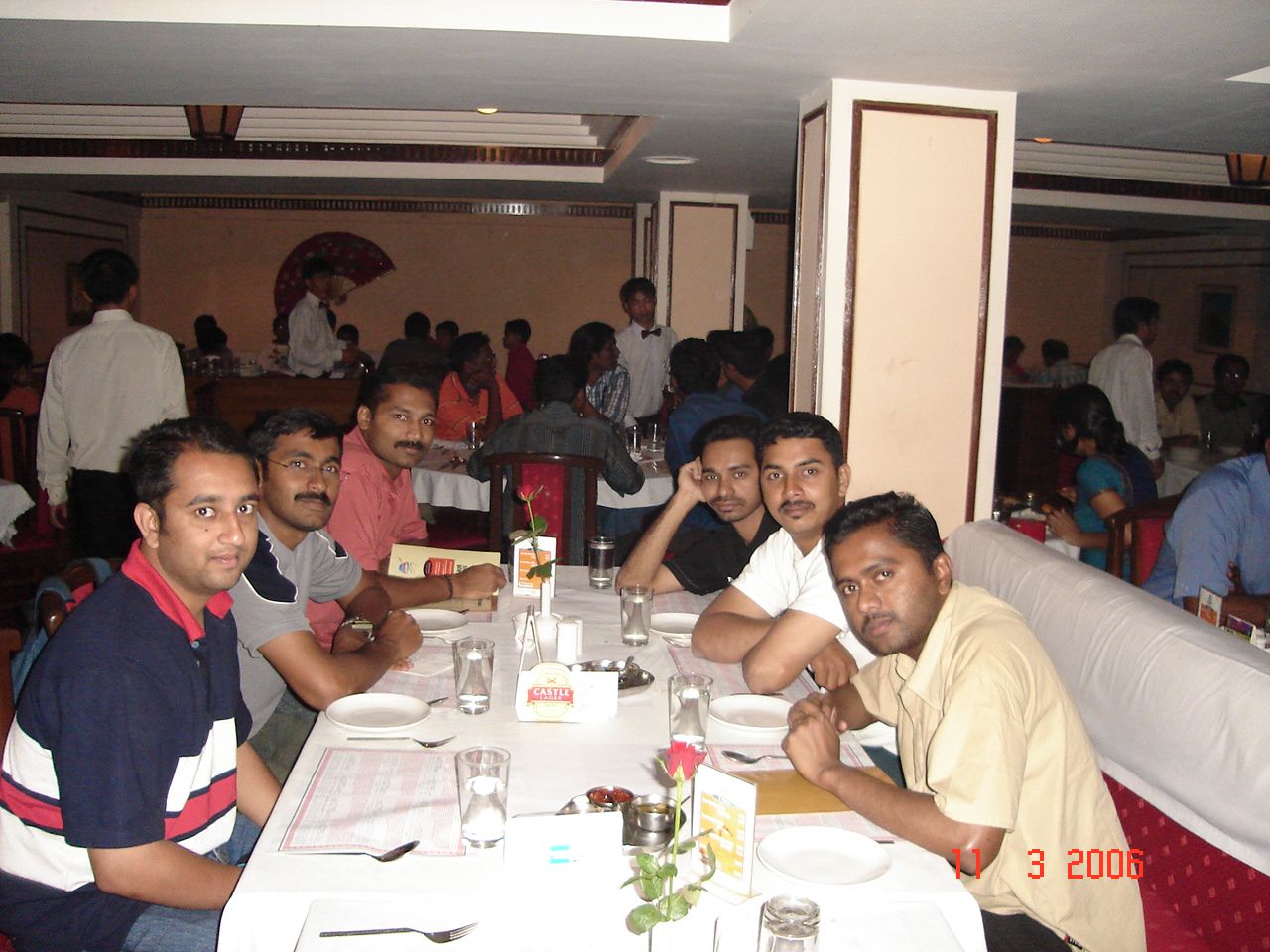 a group of men sitting around a dinner table