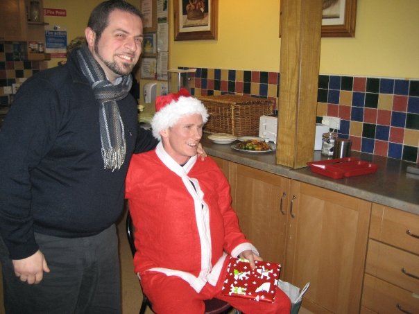 man standing near woman in kitchen wearing christmas attire