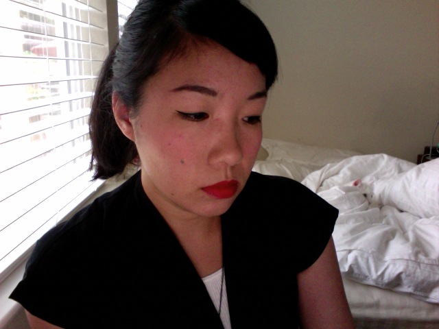 a woman with a red lip wearing a black shirt