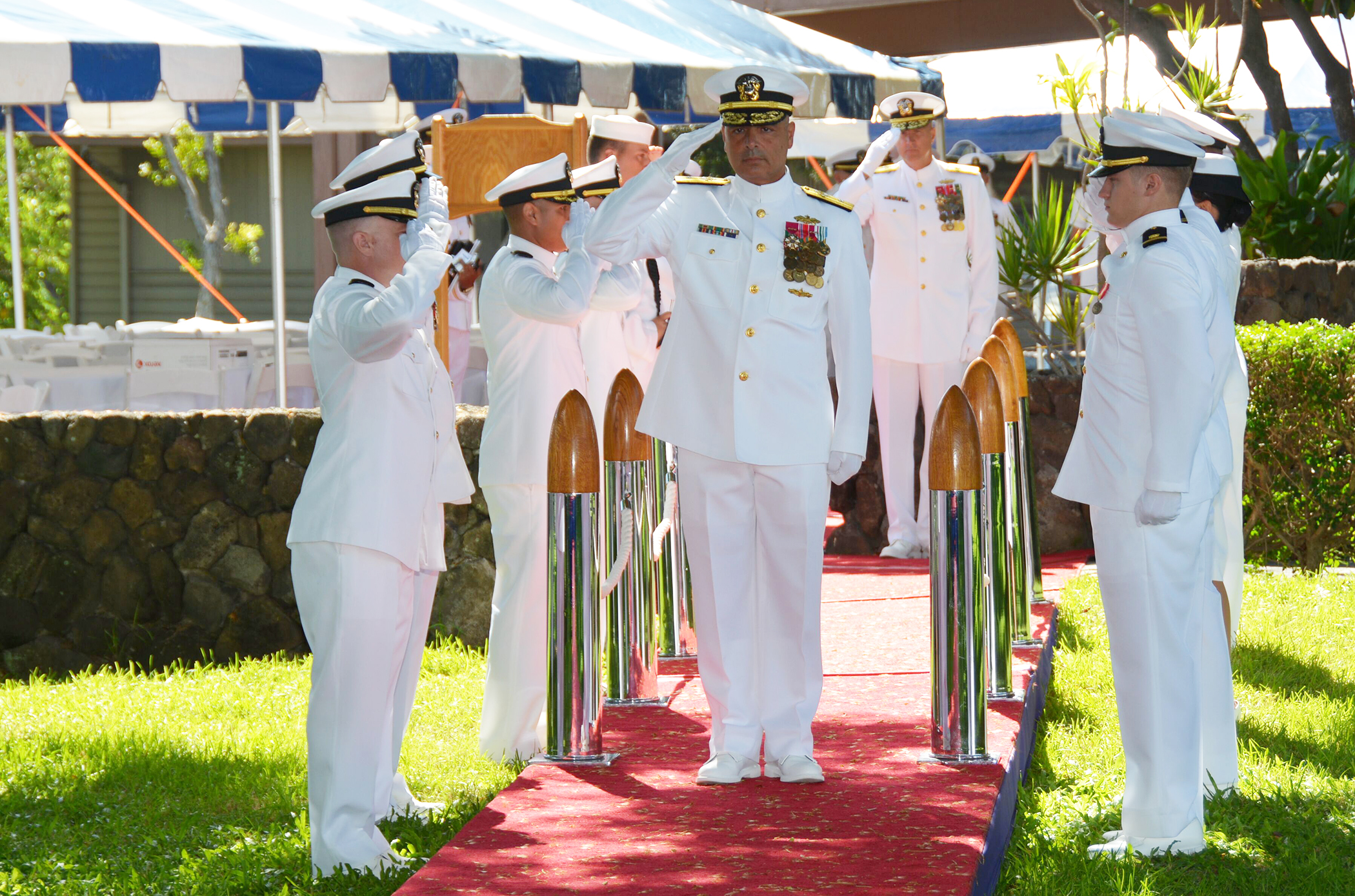 military men standing on a red carpet with medals