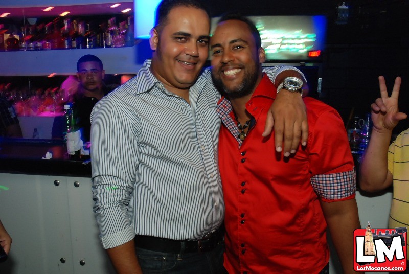 two men posing for the camera at a party