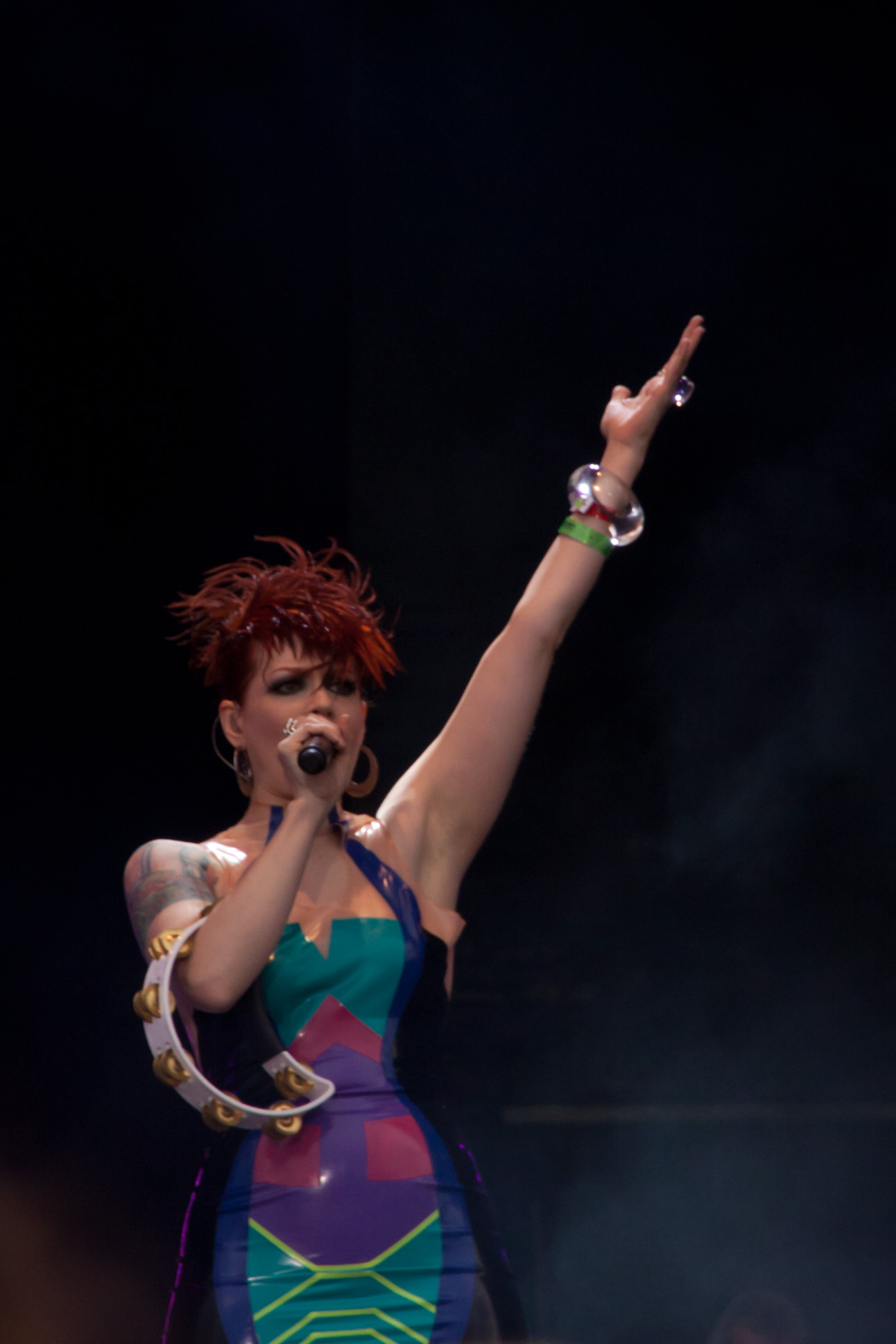 a woman in colorful dress holding a microphone