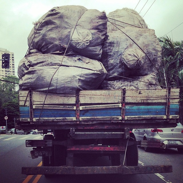 the back of a truck carrying many large sacks