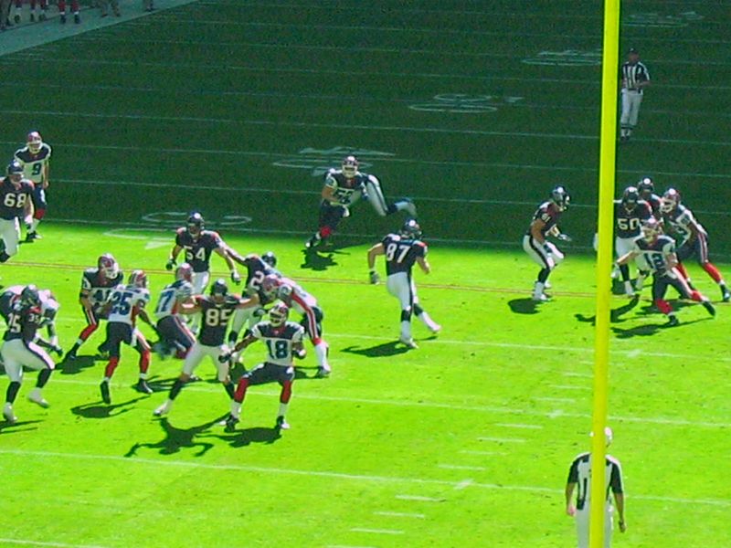 a team of football players running down a field
