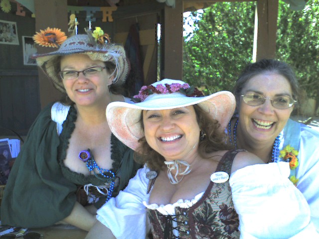three women wearing hat hats on the back of their heads