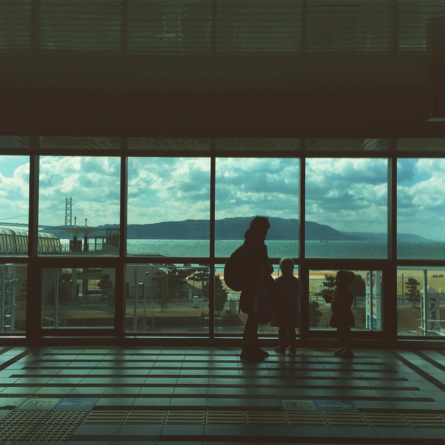 a man and a child standing in an airport