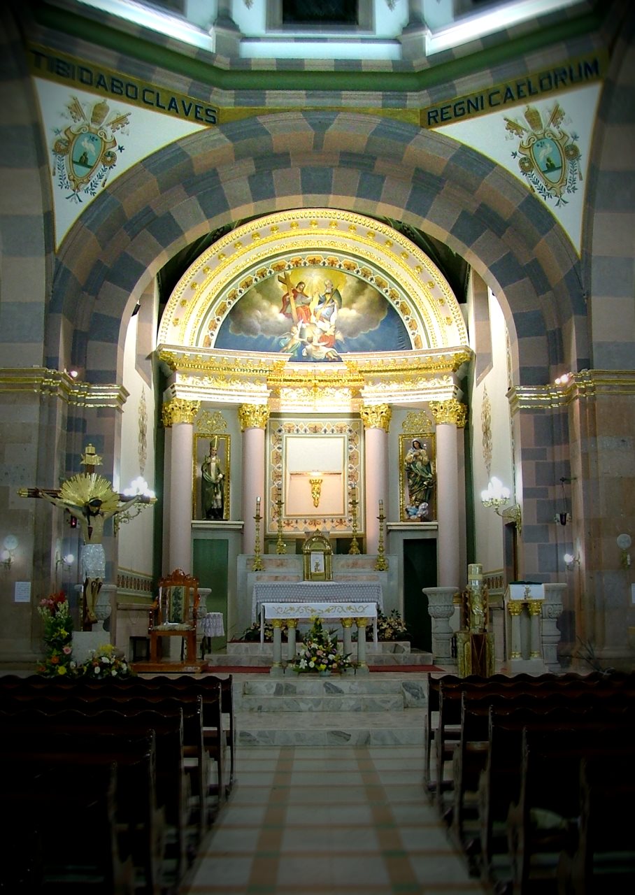 the inside of an old church with the alter lit by candles