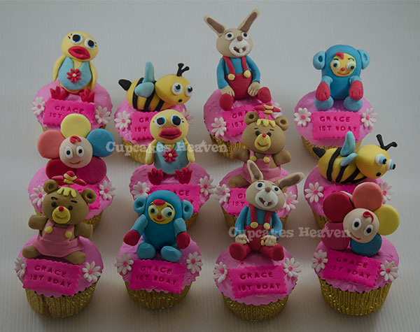 an assortment of cupcakes and pastries with toy animals