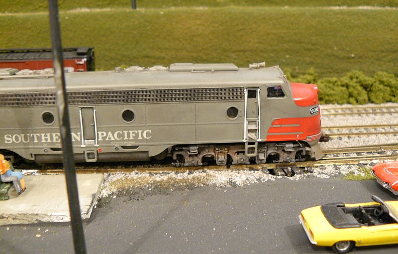 a model train with a few toy people on it