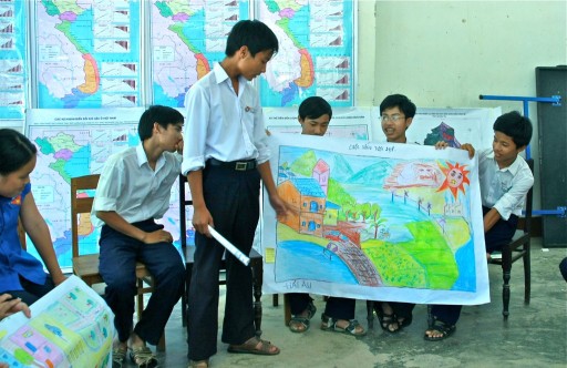 a group of boys with maps and books