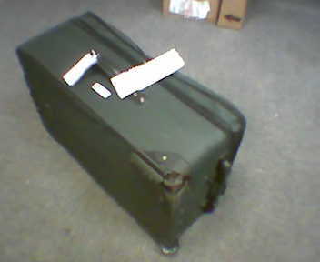 a suitcase with one handle and two tags on top