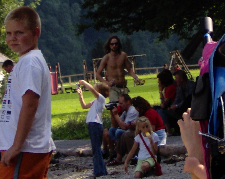a group of people sitting around a boy taking pictures