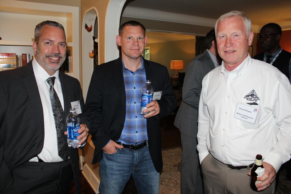 four men are smiling for a picture