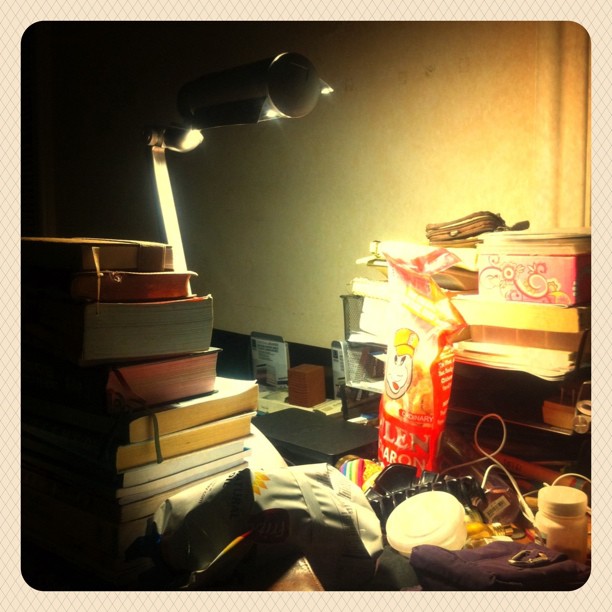 a lamp on a desk and some books