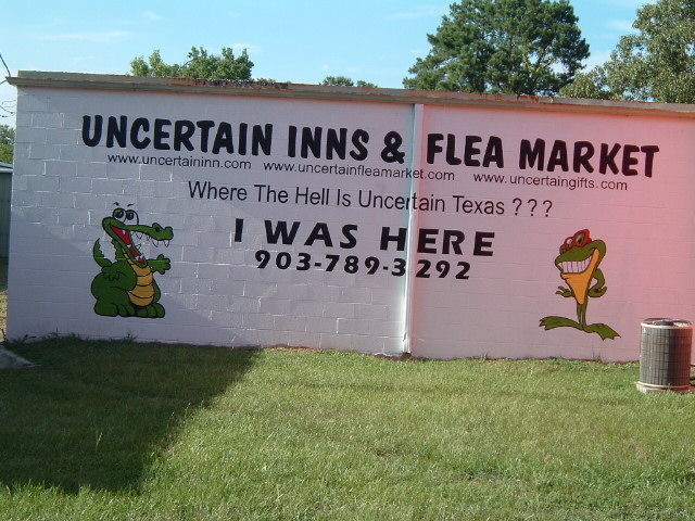 a picture of a sign for a flea market in the day