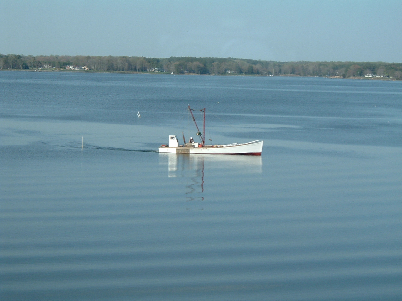 there is a boat sitting on the calm water