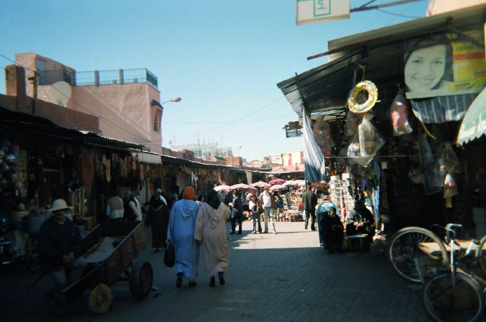 several people are walking through the marketplace area