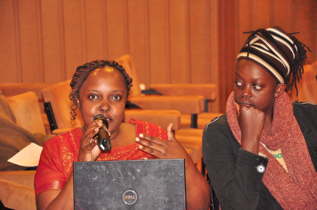 two women in front of a laptop looking off to the right