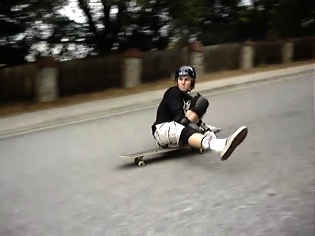 a person riding a skate board in the street