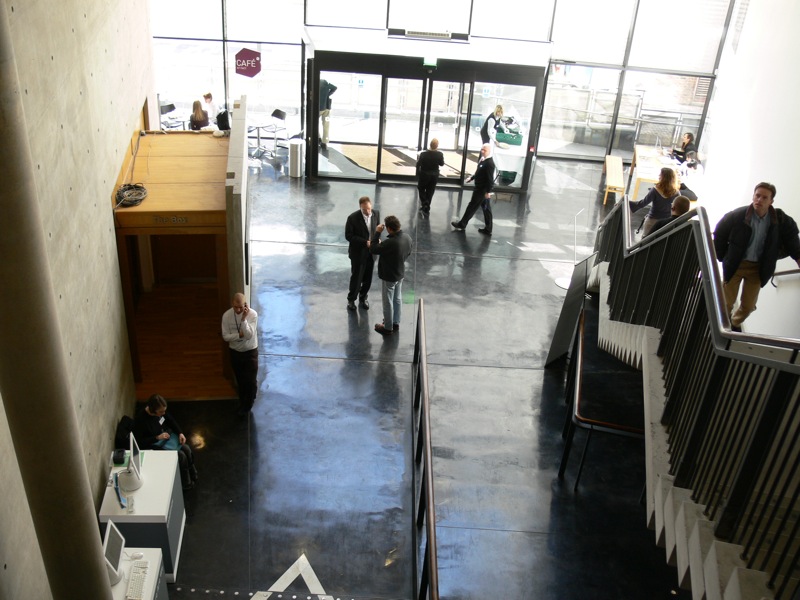 a group of people stand at an airport terminal