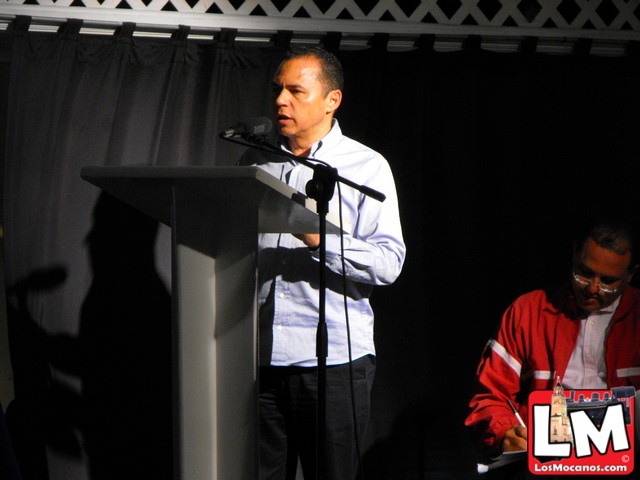 a man stands at a podium giving a speech