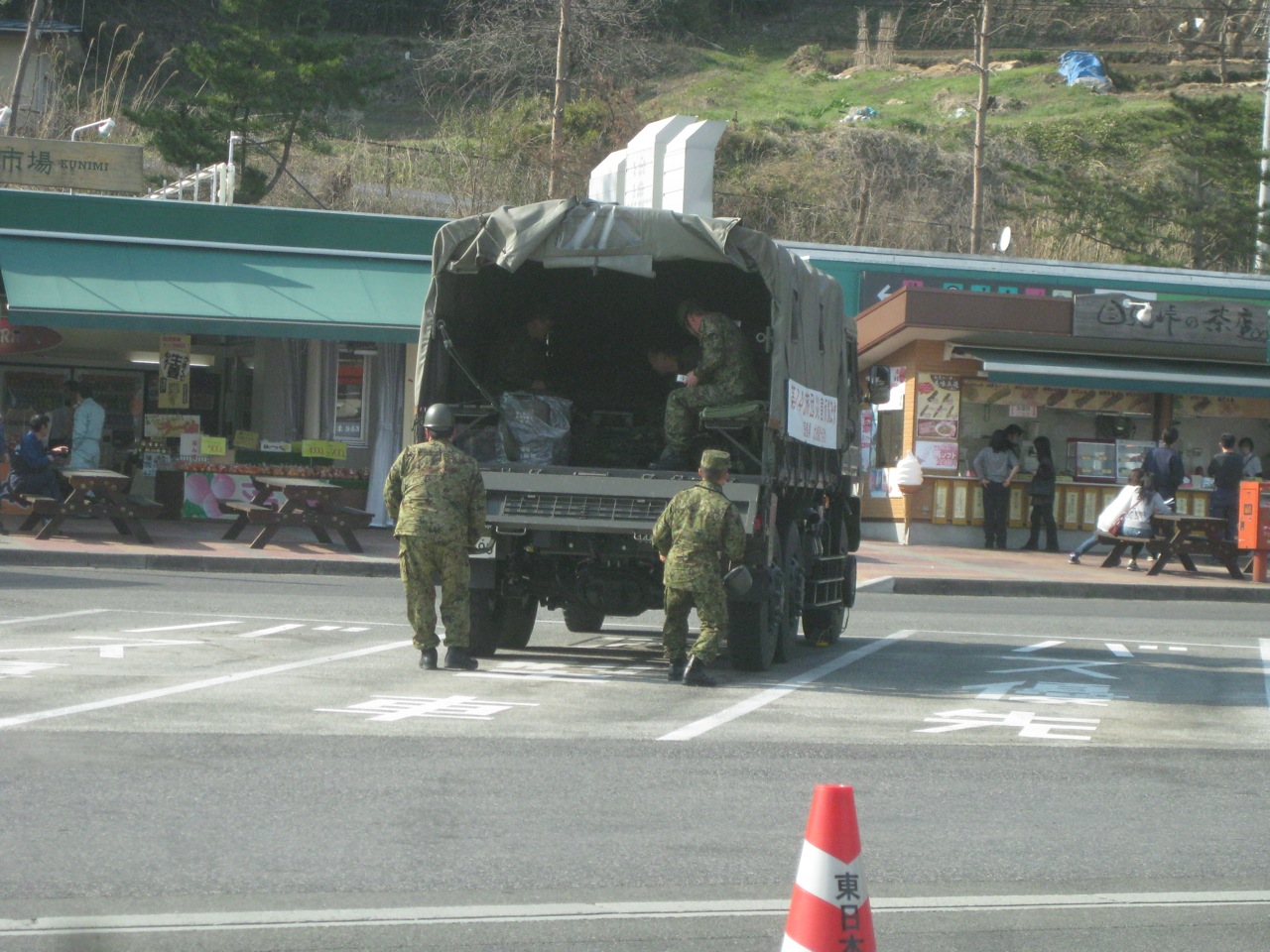 two soldiers walking toward a military vehicle