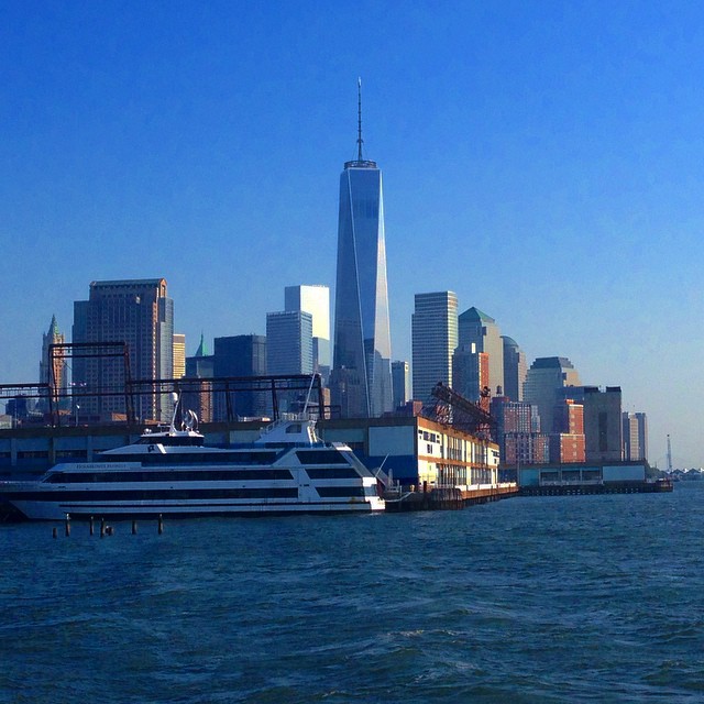 a large boat on the water near a city