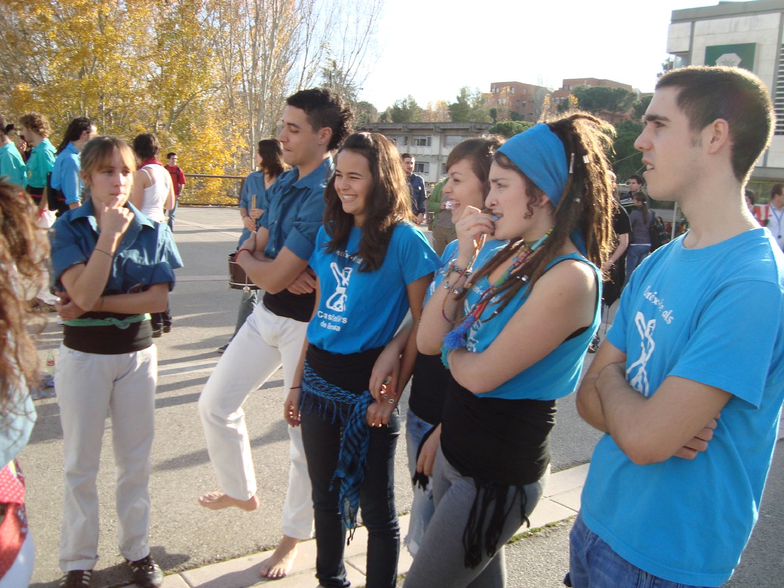 a group of people standing on the side of a road