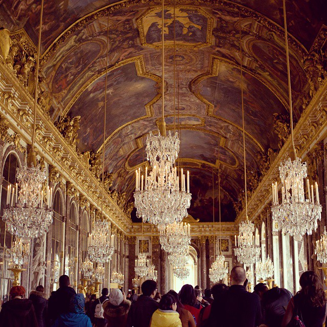 a huge chandelier and many people in the hall