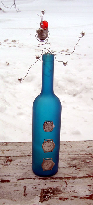 a blue glass bottle sitting on a wooden table