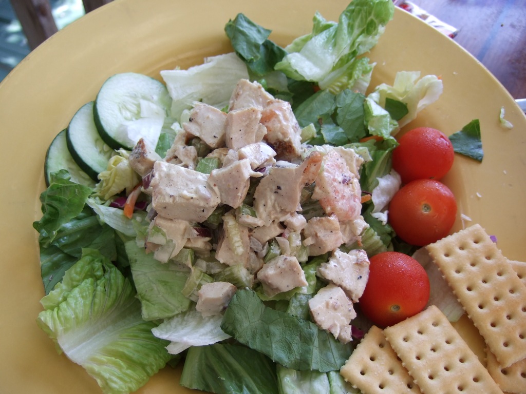 a salad is sitting in a plate with ers