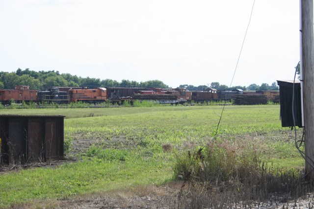 a train yard with several railroad cars on a track