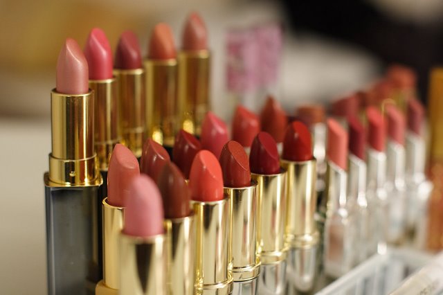 multiple lipsticks lined up in rows on display