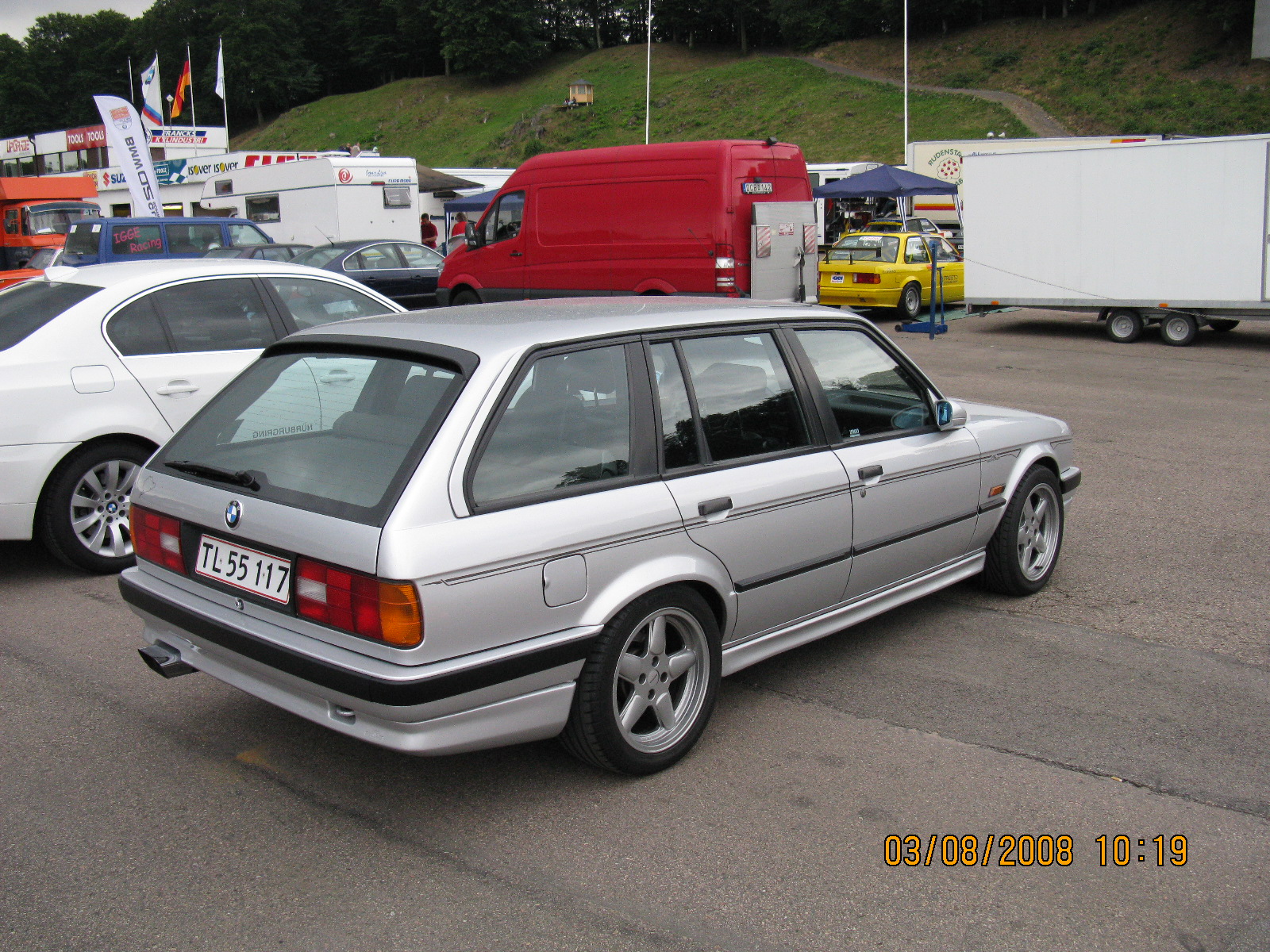 bmw was parked out next to some other vehicles