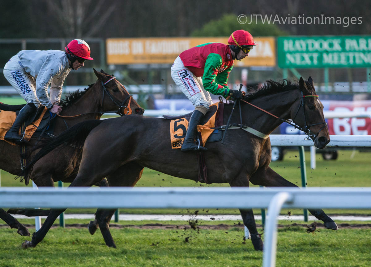 the horses are racing each other at the race track