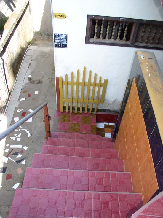 a pair of steps leading to a yellow fence
