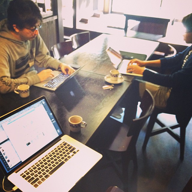 two people working on their laptops at a table