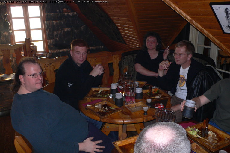 several people sitting around a table having dinner