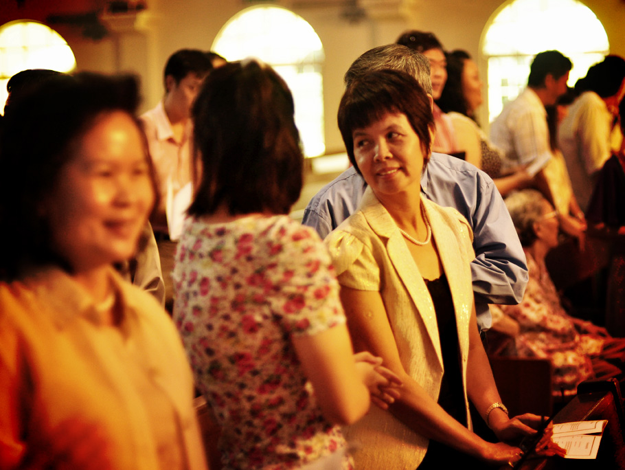 several people are having a conversation in a hall