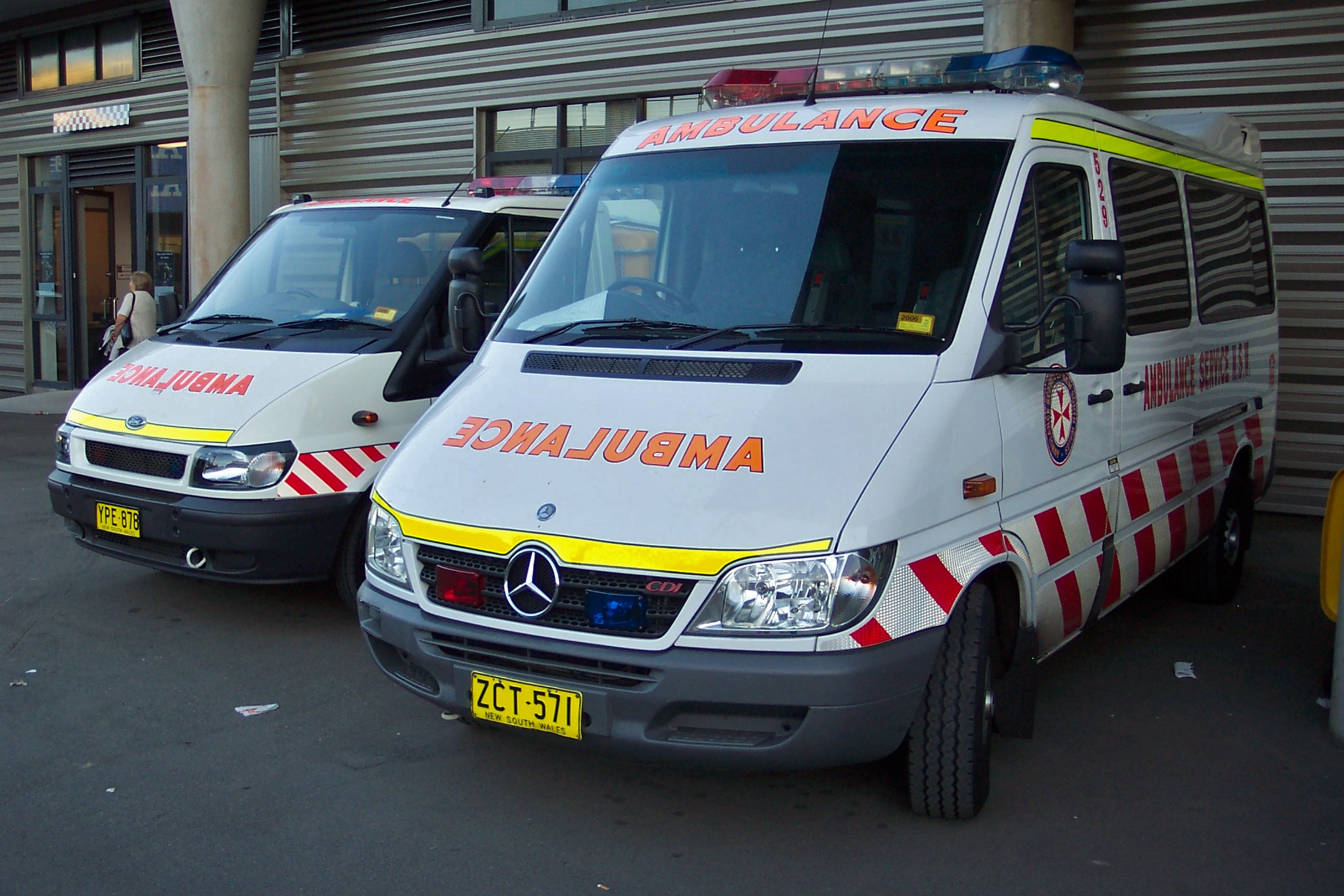 two ambulance vans are parked next to each other