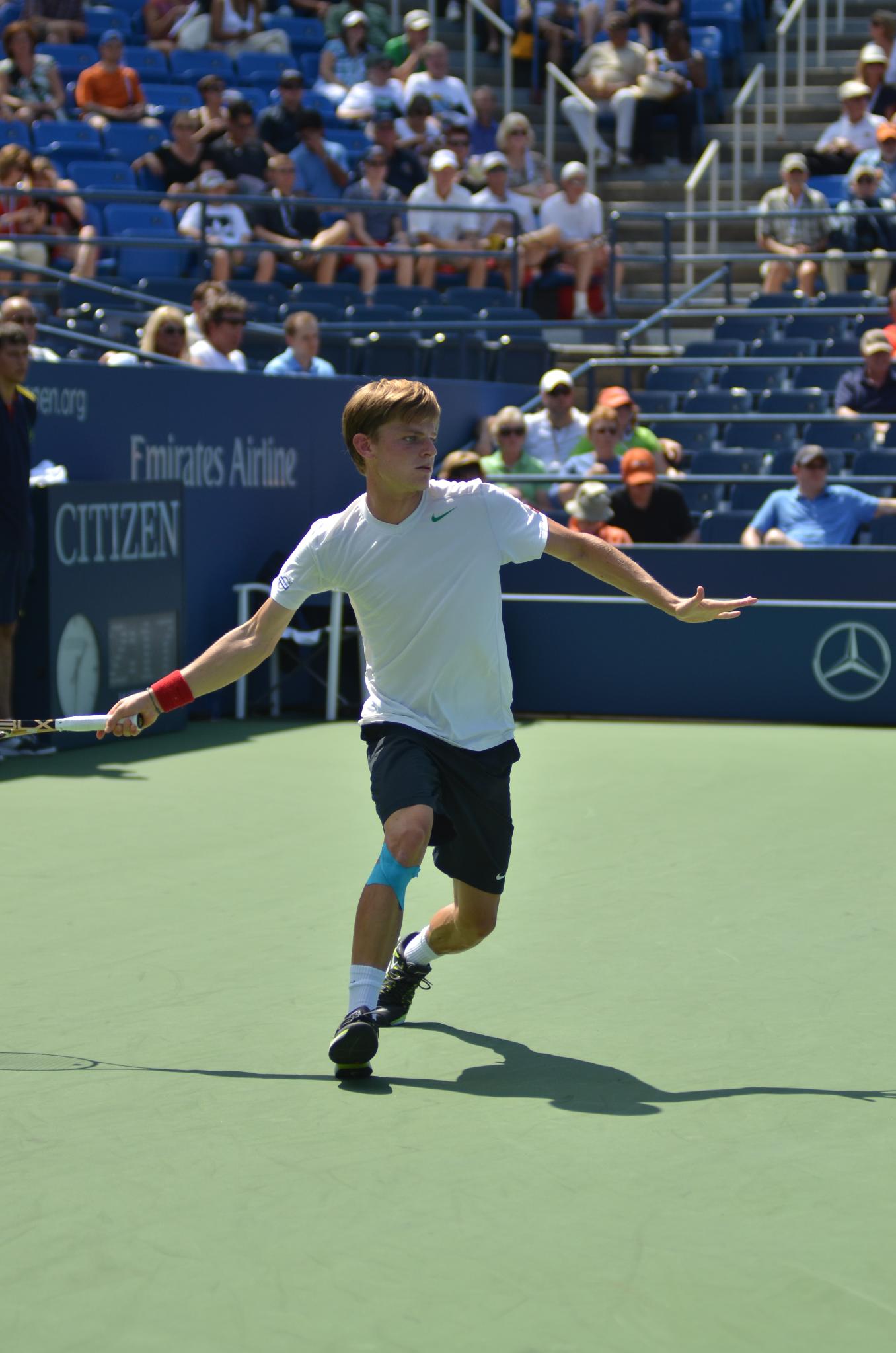 a man running across a tennis court during a tennis match